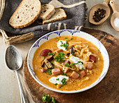 Sauerkraut soup with mushrooms and meat garnish