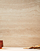 Brown marbled background, brown glass, napkin