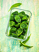 Frozen wild garlic cubes in glass containers