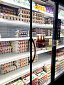Shelf with various egg cartons in the supermarket