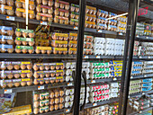 Chilled shelf with different types of eggs in cartons