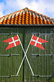 Skagen, Denmark. Green barn with Denmark flag.