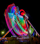 Colorful motion blur of spinning ride at a carnival.