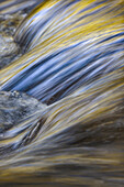 Spring foliage colors and sky reflecting on ripples on small stream, Great Smoky Mountains National Park, Tennessee