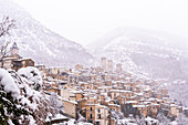 The panoramic medieval village of Pacentro under heavy snowfall with the castle, the tower bell and snow covered house, Pacentro municipality, Maiella national park, L’aquila province, Abruzzo, Italy