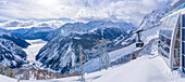 View of snow covered Aosta Valley, mountains and Skyway Monte Bianco cable car in winter, Courmayeur, Aosta Valley, Italian Alps, Italy