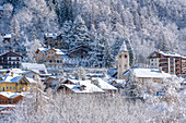 View of snow covered trees and Courmayeur from Dolonne in winter, Courmayeur, Aosta Valley, Italian Alps, Italy
