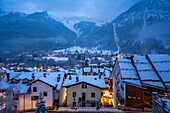 View of the snow covered town centre and mountainous background in winter, Courmayeur, Aosta Valley, Italian Alps, Italy