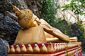 Reclining Buddha statue on the path to the stupa of Wat Chom Si on the summit of Mount Phu Si, Luang Prabang, northern Laos