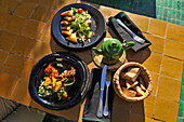Assortment of Moroccan salads and mixed briouates, served at the restaurant Le Jardin in the Medina, Marrakesh, Morocco