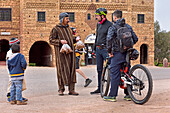 Bike riders in front of the Auberge-restaurant in the village of Telouet, Ouarzazate Province, region of Draa-Tafilalet, Morocco