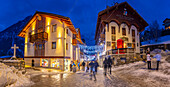 View of Christmas lights and decorations in Piazza Abbe Henry at dusk, Courmayeur, Aosta Valley, Italy