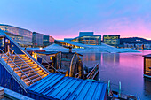View of Opera House and harbourside saunas during winter at sunrise, Oslo, Norway, Scandinavia