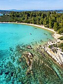 Diaporos island with wild beaches and a kayak on the turquoise water, drone aerial view, Chalkidiki, Greece