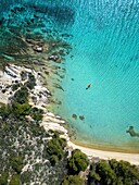 Diaporos island with wild beaches and kayak on the turquoise water, drone top aerial view, Chalkidiki, Greece