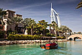 Burj Al Arab, the world's only seven star hotel, seen from Madinat Jumeirah, a luxury resort of hotels and souk, Dubai, United Arab Emirates