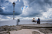Two female friends sitting and talking in viewpoint of Nazare
