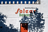 Sanlucar, Spain, Aug 22 2020, The bright Manzanilla Solear sign shines against the white wall of Barbadillo winery in Sanlucar de Barrameda's Barrio Alto.