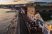 Aerial view of waterside Cais do Sodre and Titanic sur Mer at sunset, a buzzing nightlife and dining destination in Lisbon, Portugal