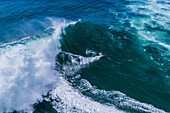 Aerial drone view of Big wave surfing in Praia do Norte (North Beach), listed on the Guinness World Records for the biggest waves ever surfed, formed under the influence of the Nazare Canyon, Portugal
