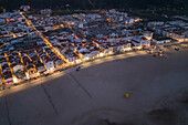 Aerial view of Nazare beach and cityscape at night, Portugal