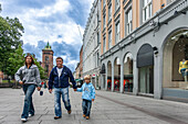Oslo, Norway, Aug 10 2017, A diverse family enjoys a stroll down Karl Johans street in Oslo, Norway, against a backdrop of shops and historic architecture.