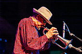 Sanlucar de Barrameda, Spain, Jul 17 2004, Jerry Gonzalez performs passionately, playing trumpet live with a hat and sunglasses.