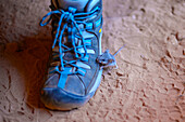 Little mouse climbing on a hiker´s boot