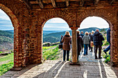 Visitors admire the picturesque landscape from the ancient structure of Mezquita Califal, a significant site in Almonaster la Real.