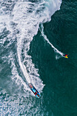 Aerial drone view of Big wave surfing in Praia do Norte (North Beach), listed on the Guinness World Records for the biggest waves ever surfed, formed under the influence of the Nazare Canyon, Portugal