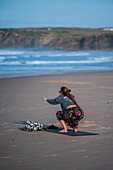 Young woman training strength and mobility on the beach of Baleal Island