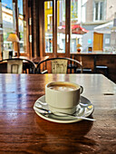 Serene atmosphere inside a coffee shop in Seville with a cup of coffee.