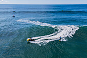 Aerial drone view of Big wave surfing in Praia do Norte (North Beach), listed on the Guinness World Records for the biggest waves ever surfed, formed under the influence of the Nazare Canyon, Portugal