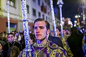 Seville, Spain, Apr 2 2010, An acolyte stands with a cirial, participating in the solemn Holy Week procession of the Macarena brotherhood in Seville, Spain.