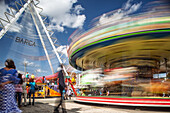 Seville, Spain, Apr 29 2009, A colorful carousel spins rapidly at Calle del Infierno during the lively April's Fair in Seville, captivating visitors and families.