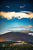 A clear night reveals a sky filled with stars above Canigou mountain and the Pyrenees, seen from the village of Eus in Languedoc-Roussillon.