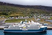 Aerial view of SH Vega cruise is an expedition cruise ship operated by Swan Hellenic, docked in Seyðisfjörður harbour Seydisfjordur, Iceland.