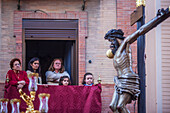 Seville, Spain, Apr 2 2010, Women on their balcony admire the Cristo del Buen Fin during Seville's Holy Week, celebrating a cherished family tradition.