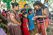 Tourist interacting with locals in Guaymi Mountain Village (Ngäbe-Buglé (Guaymi)), Panama