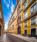 Beautiful street showcasing historic architecture of Capilla de los Luises in Seville.