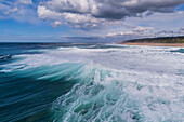 Aerial drone view of Big wave surfing in Praia do Norte (North Beach), listed on the Guinness World Records for the biggest waves ever surfed, formed under the influence of the Nazare Canyon, Portugal