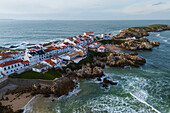 Aerial view of Vestigios do Forte, the rocky cliffs of Baleal Island and local architecture, Portugal
