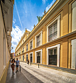 Seville, Spain, May 15 2022, Beautiful street view of peaceful sunny day in colorful Seville on Calle San Vicente.