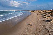 Aerial view of two women walking on Praia da Cova da Alfarroba/Praia do Baia in Peniche