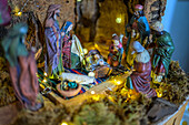 A traditional nativity scene highlights the nativity scene in a charming Sevilla home, adorned with delicate lights and intricate figures.