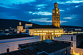 The Church of La Granada stands beautifully lit against the evening sky in Llerena, Extremadura, showcasing stunning architecture.