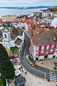 Aerial view of traditional yellow tram in the streets of Alfama, Lisbon, Portugal