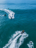 Aerial drone view of Big wave surfing in Praia do Norte (North Beach), listed on the Guinness World Records for the biggest waves ever surfed, formed under the influence of the Nazare Canyon, Portugal