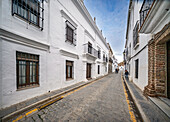 Llerena, Spain, Nov 30 2024, Visitors stroll along the cobblestone street of Calle Corredera, admiring the whitewashed Mediterranean architecture in Llerena.