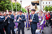 Seville, Spain, Apr 2 2010, Soft strains of oboe, clarinet, and bassoon fill the streets as the Vera Cruz brotherhood marches through Seville, honoring Holy Week.
